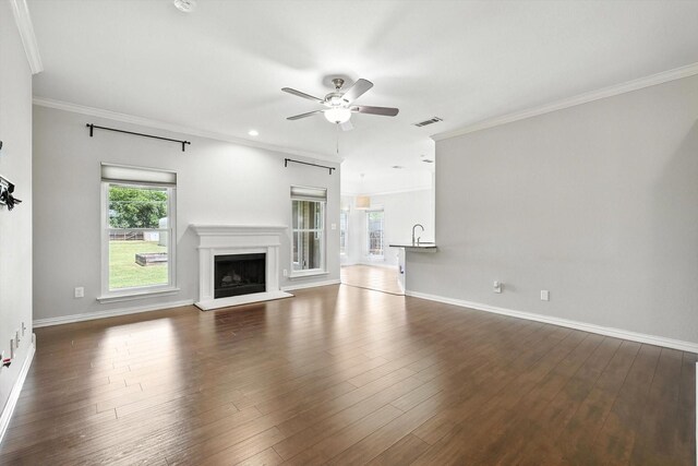 638 Lakeshore Blvd, Oak Point, TX 75068 - unfurnished living room with ceiling fan, ornamental molding, a fireplace with raised hearth, and dark wood-type flooring
