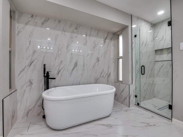 1044 Peach Ln, Desoto, TX 75115 - bathroom featuring a marble finish shower, marble tiled flooring, and a soaking tub