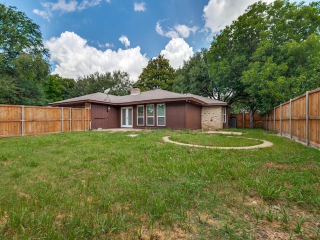 1044 Peach Ln, Desoto, TX 75115 - rear view of property featuring french doors, a fenced backyard, and a chimney