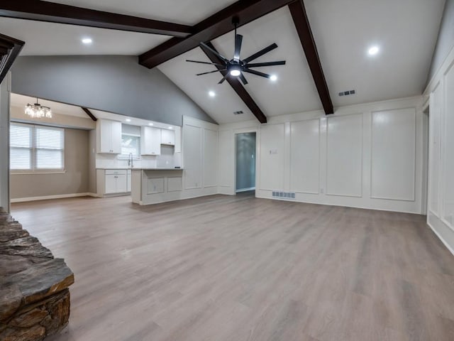 1044 Peach Ln, Desoto, TX 75115 - unfurnished living room featuring a chandelier, a ceiling fan, light wood finished floors, recessed lighting, and a decorative wall