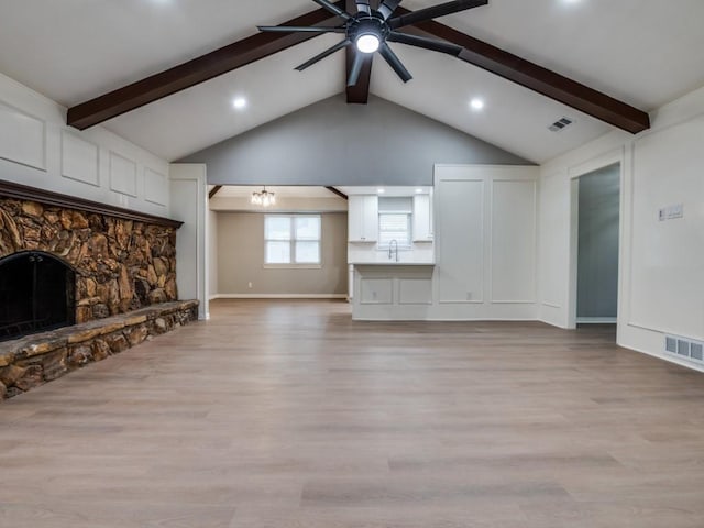 1044 Peach Ln, Desoto, TX 75115 - unfurnished living room featuring ceiling fan, a chandelier, light wood-style floors, a stone fireplace, and recessed lighting