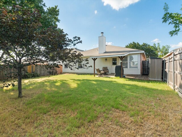 1545 Knottingham Dr, Little Elm, TX 75068 - back of house with a fenced backyard, a chimney, and a patio area