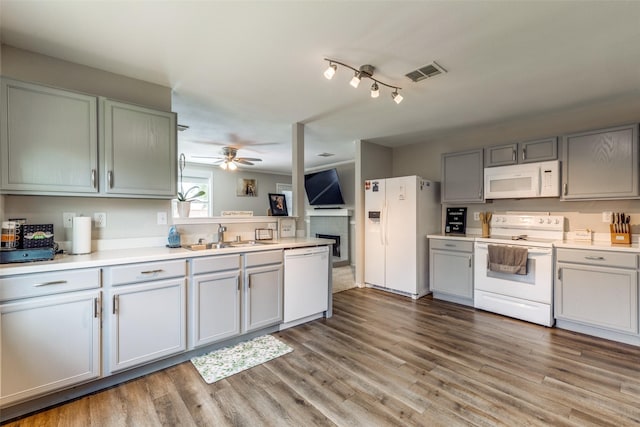 8426 Jacaranda Way, Arlington, TX 76002 - kitchen featuring white appliances, a fireplace, light countertops, ceiling fan, and wood finished floors