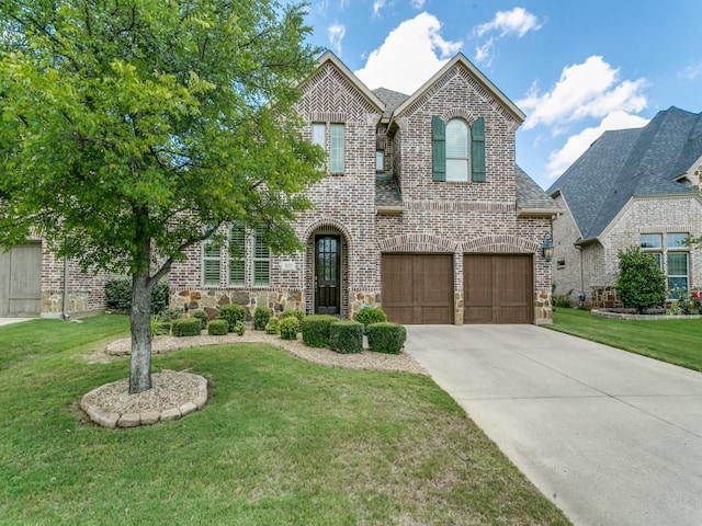 322 Hill Creek Ln, Grapevine, TX 76051 - view of front of property featuring brick siding, a garage, driveway, and a front lawn