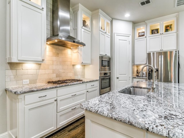 322 Hill Creek Ln, Grapevine, TX 76051 - kitchen with wall chimney range hood, appliances with stainless steel finishes, white cabinets, dark wood-style floors, and glass insert cabinets