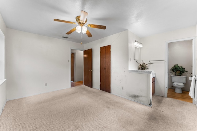 1238 Caladium Dr, Mesquite, TX 75149 - unfurnished bedroom featuring light carpet, ensuite bath, and a ceiling fan