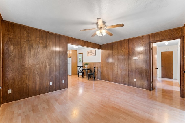 1238 Caladium Dr, Mesquite, TX 75149 - unfurnished room featuring wood walls, a ceiling fan, and wood finished floors