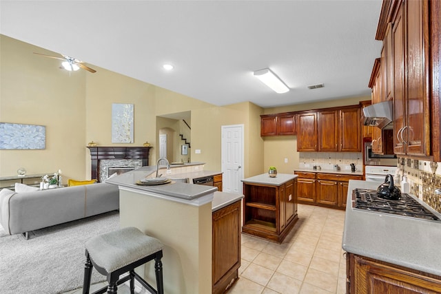 14779 Blakehill Dr, Frisco, TX 75035 - kitchen with a kitchen island with sink, wall chimney range hood, open floor plan, appliances with stainless steel finishes, and ceiling fan