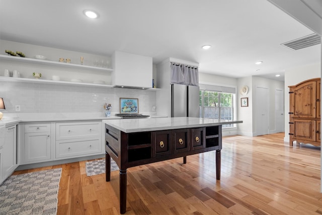 1811 Laurelwood Dr, Denton, TX 76209 - kitchen featuring open shelves, light countertops, light wood-style flooring, freestanding refrigerator, and recessed lighting