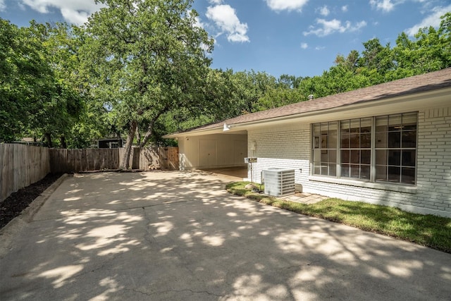 1811 Laurelwood Dr, Denton, TX 76209 - view of property exterior featuring brick siding, concrete driveway, a carport, and a patio