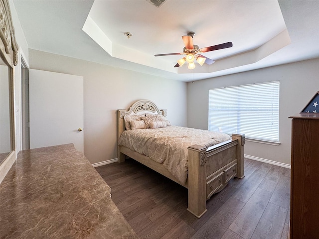 614 Torero Dr, Oak Point, TX 75068 - bedroom with a tray ceiling, dark wood finished floors, and a ceiling fan