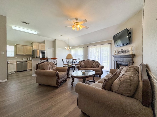 614 Torero Dr, Oak Point, TX 75068 - living area with wood finished floors, a ceiling fan, healthy amount of natural light, lofted ceiling, and a fireplace