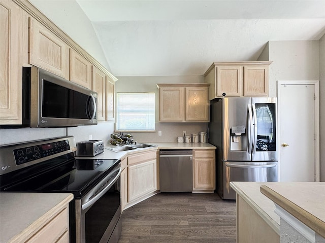 614 Torero Dr, Oak Point, TX 75068 - kitchen with stainless steel appliances, light brown cabinetry, vaulted ceiling, and light countertops