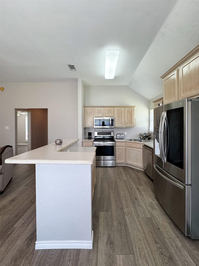 614 Torero Dr, Oak Point, TX 75068 - kitchen featuring appliances with stainless steel finishes, light brown cabinets, light countertops, dark wood-type flooring, and lofted ceiling