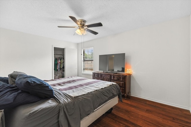 4900 Highbank Dr, Arlington, TX 76018 - bedroom with dark wood finished floors, a ceiling fan, a walk in closet, a closet, and a textured ceiling