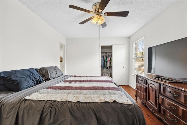 4900 Highbank Dr, Arlington, TX 76018 - bedroom with a textured ceiling, dark wood-style floors, a closet, and ceiling fan