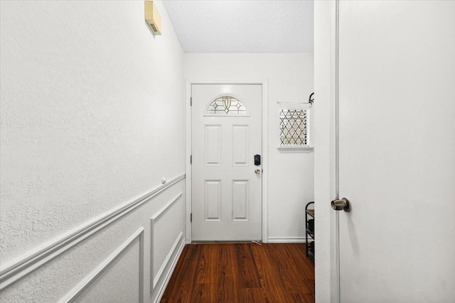 4900 Highbank Dr, Arlington, TX 76018 - doorway to outside featuring dark wood-style floors and a textured ceiling