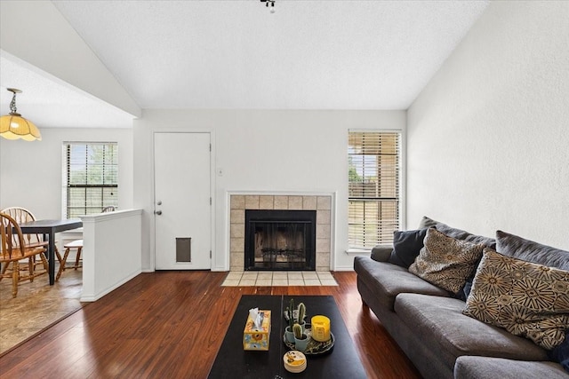4900 Highbank Dr, Arlington, TX 76018 - living area with wood finished floors, a fireplace, and vaulted ceiling