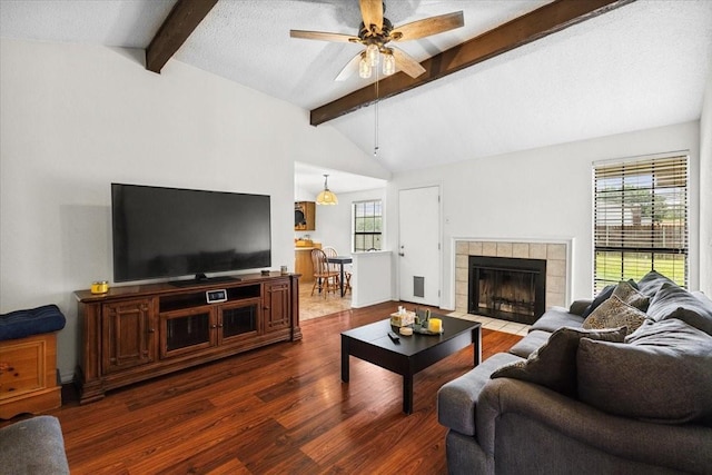 4900 Highbank Dr, Arlington, TX 76018 - living area with dark wood-style flooring, ceiling fan, and a tiled fireplace