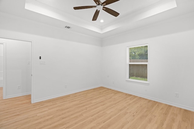 301 Henry St, Waxahachie, TX 75165 - empty room featuring a tray ceiling, light wood-style flooring, ceiling fan, ornamental molding, and recessed lighting