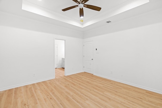 301 Henry St, Waxahachie, TX 75165 - unfurnished room with a raised ceiling, a ceiling fan, crown molding, and light wood finished floors