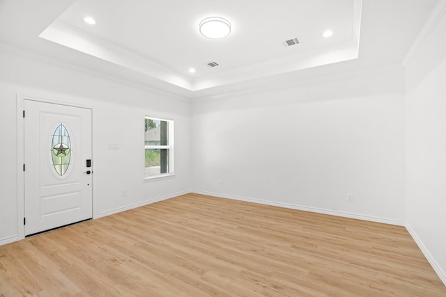 301 Henry St, Waxahachie, TX 75165 - foyer featuring a raised ceiling, ornamental molding, light wood-style floors, and recessed lighting