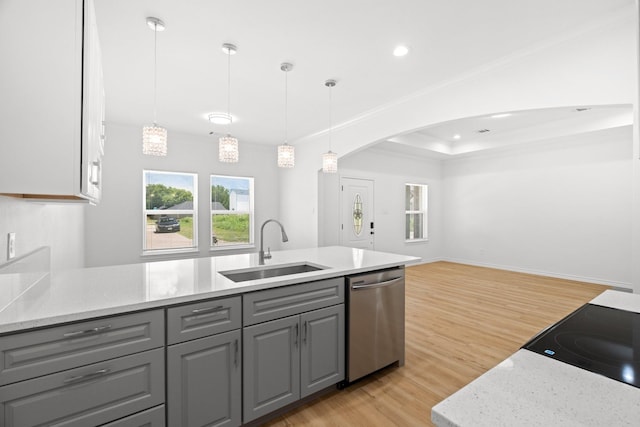 301 Henry St, Waxahachie, TX 75165 - kitchen with dishwasher, gray cabinets, light wood-type flooring, arched walkways, and open floor plan