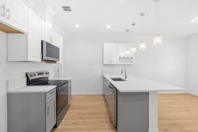 301 Henry St, Waxahachie, TX 75165 - kitchen featuring range with electric stovetop, a peninsula, light wood-style flooring, stainless steel dishwasher, and light countertops