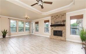 4360 Flint Oak Dr, Belton, TX 76513 - unfurnished living room with ornamental molding, a raised ceiling, a fireplace, healthy amount of natural light, and ceiling fan