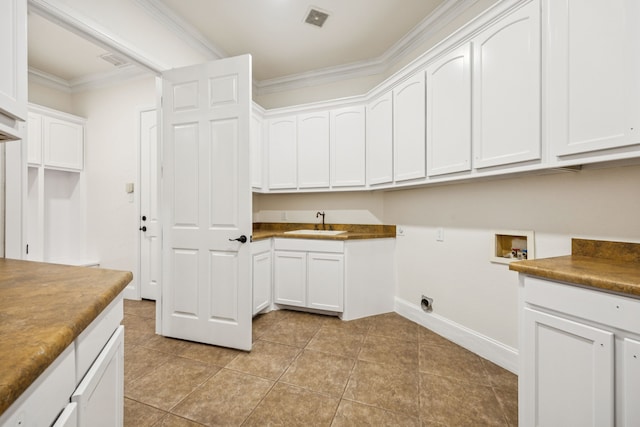 8012 Rushing Spring Dr, North Richland Hills, TX 76182 - washroom with hookup for a washing machine, ornamental molding, light tile patterned flooring, cabinet space, and electric dryer hookup