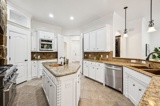 8012 Rushing Spring Dr, North Richland Hills, TX 76182 - kitchen featuring stainless steel appliances, decorative backsplash, light tile patterned floors, white cabinets, and crown molding