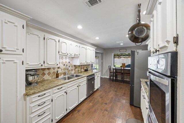 1507 Greenbrier Dr, Sherman, TX 75092 - kitchen featuring stainless steel appliances, white cabinetry, tasteful backsplash, recessed lighting, and dark wood finished floors