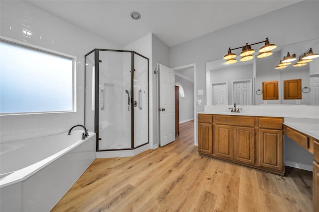 6814 Galway Dr, Garland, TX 75044 - bathroom with vanity, a shower stall, a garden tub, and wood finished floors