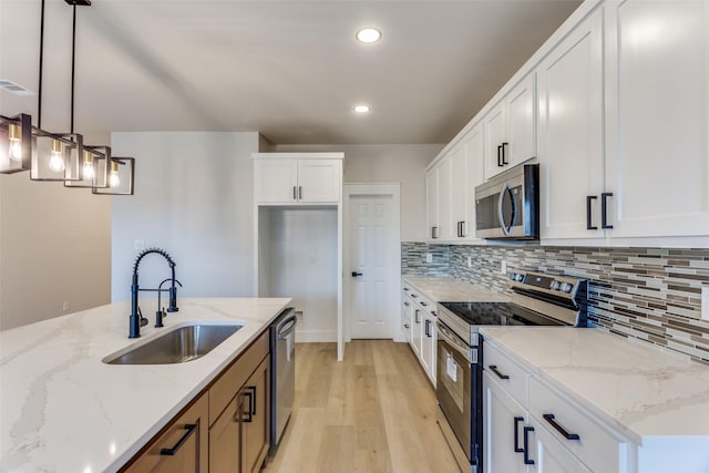 5223 Fletcher Ave, Fort Worth, TX 76107 - kitchen with stainless steel appliances, recessed lighting, light wood-style flooring, decorative backsplash, and light stone counters