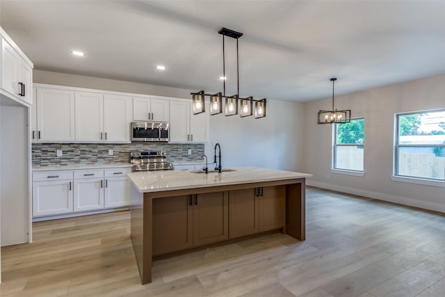 5223 Fletcher Ave, Fort Worth, TX 76107 - kitchen with stainless steel appliances, white cabinets, decorative backsplash, light wood-style floors, and recessed lighting