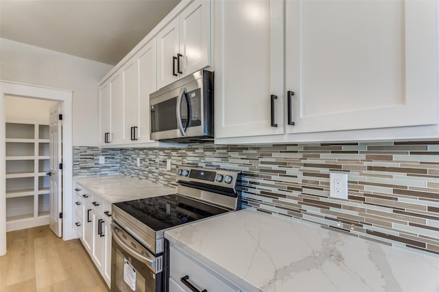 5223 Fletcher Ave, Fort Worth, TX 76107 - kitchen featuring stainless steel appliances, white cabinetry, and backsplash