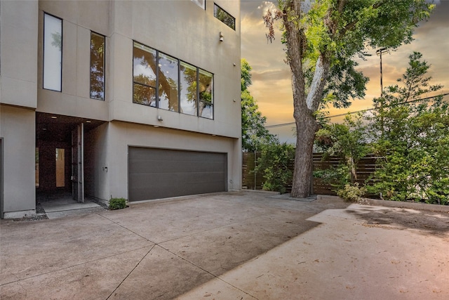 1505 N Haskell Ave Unit 5, Dallas, TX 75204 - view of front of house with an attached garage, concrete driveway, and stucco siding