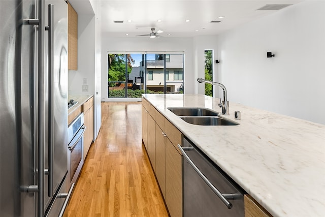 1505 N Haskell Ave Unit 5, Dallas, TX 75204 - kitchen with stainless steel appliances, light wood-type flooring, modern cabinets, recessed lighting, and light stone countertops