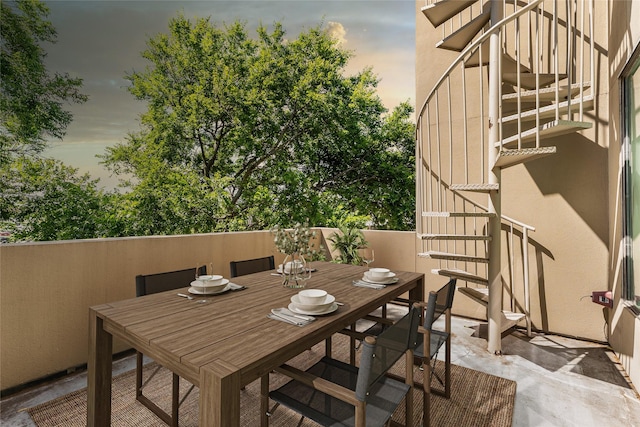 1505 N Haskell Ave Unit 5, Dallas, TX 75204 - patio terrace at dusk featuring stairs and outdoor dining space