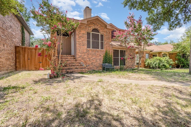 1740 Alameda Dr, Mesquite, TX 75150 - view of front facade featuring a chimney and brick siding