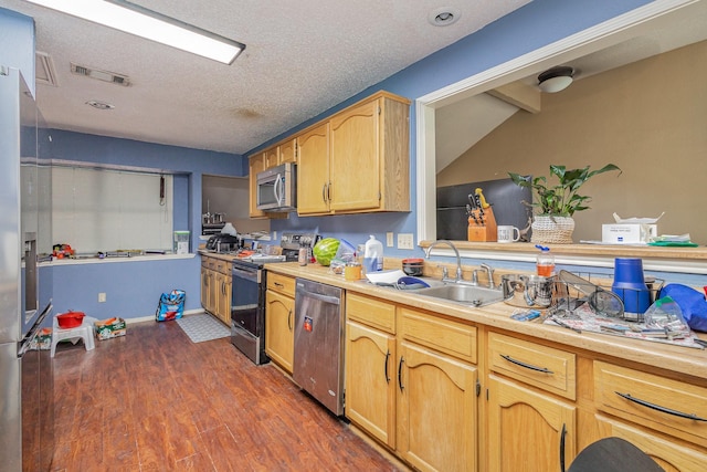 1740 Alameda Dr, Mesquite, TX 75150 - kitchen with stainless steel appliances, a textured ceiling, dark wood-type flooring, and light countertops