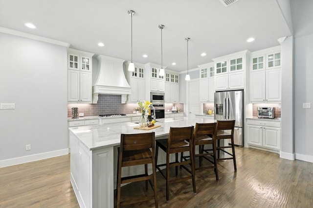 2941 American Sparrow Dr, Midlothian, TX 76065 - kitchen with appliances with stainless steel finishes, custom exhaust hood, tasteful backsplash, a large island with sink, and recessed lighting