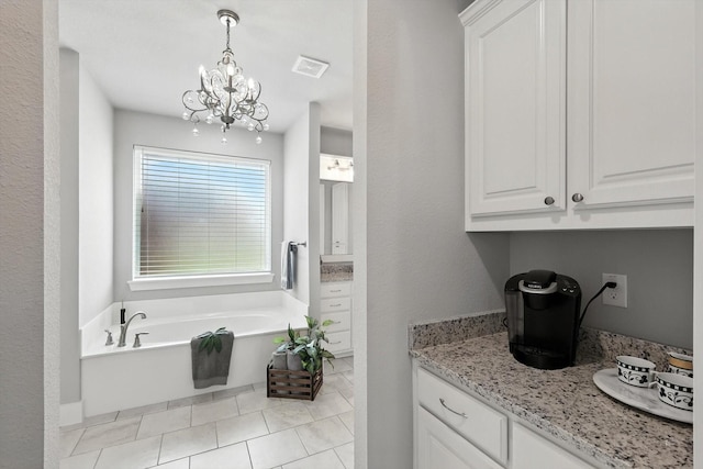 2941 American Sparrow Dr, Midlothian, TX 76065 - kitchen featuring a chandelier, white cabinetry, light stone countertops, and pendant lighting