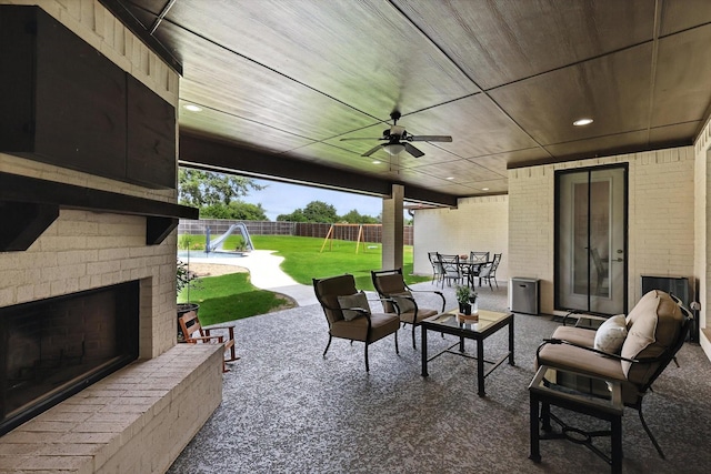 2941 American Sparrow Dr, Midlothian, TX 76065 - fenced backyard featuring a playground, a patio area, an outdoor living space with a fireplace, outdoor dining area, and a ceiling fan