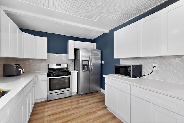 2549 Vickie St, Mesquite, TX 75149 - kitchen featuring appliances with stainless steel finishes, white cabinetry, backsplash, and light countertops