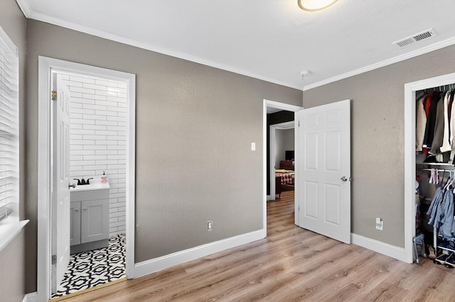 2549 Vickie St, Mesquite, TX 75149 - unfurnished bedroom featuring light wood-type flooring, ornamental molding, a closet, and ensuite bathroom