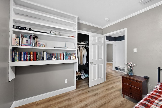2549 Vickie St, Mesquite, TX 75149 - bedroom with crown molding, light wood-style floors, and a closet