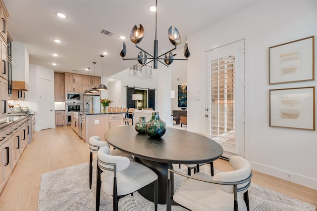 2217 Grey September St, Celina, TX 75009 - dining area featuring light wood finished floors, a chandelier, recessed lighting, and a barn door