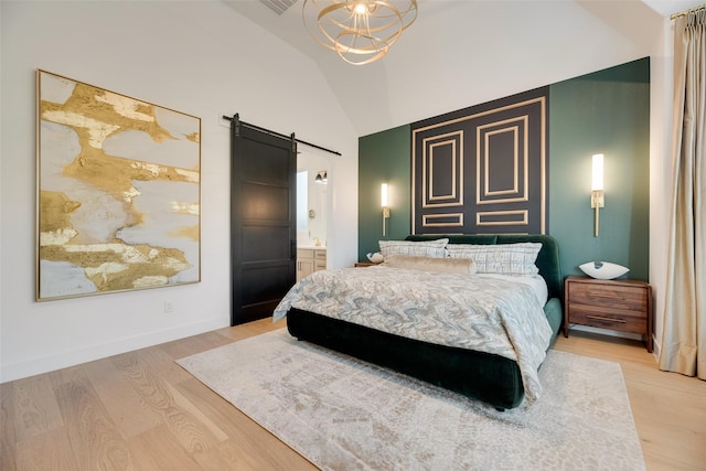 2217 Grey September St, Celina, TX 75009 - bedroom with a barn door, light wood finished floors, lofted ceiling, a chandelier, and ensuite bathroom