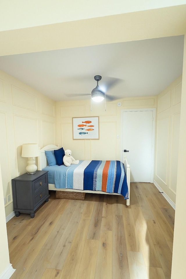 2524 Bear Haven Dr, Grapevine, TX 76051 - bedroom featuring a decorative wall, light wood-style flooring, and ceiling fan